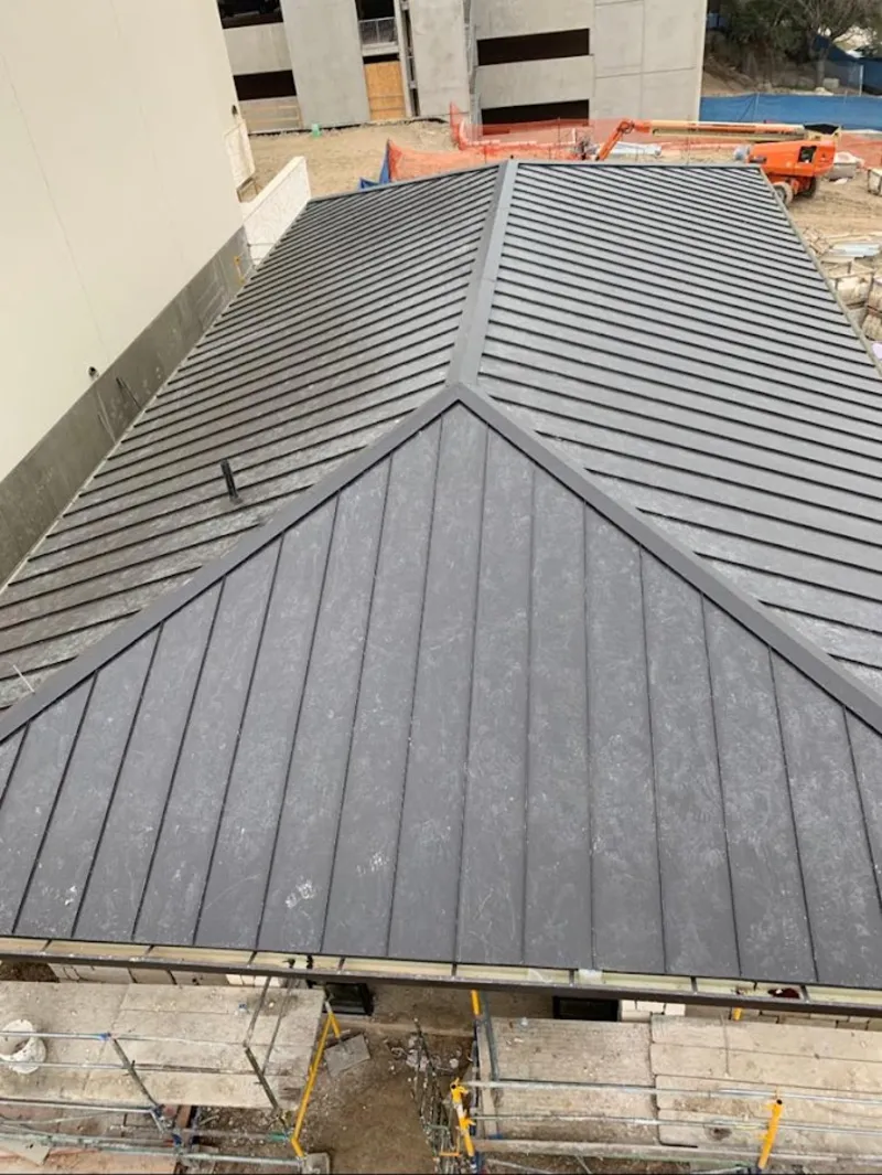 Commercial metal roof construction with crane equipment in Goose Creek