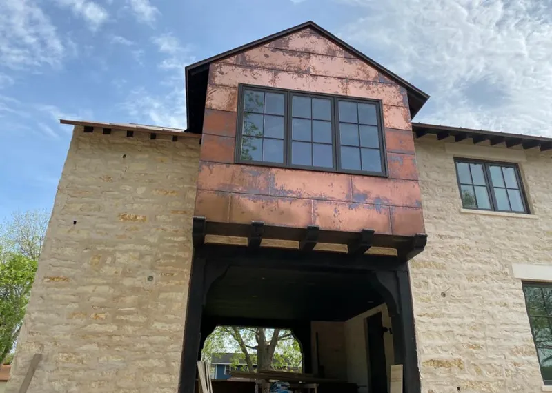 Copper metal panel facade on a stone building for Roof Repair in Goose Creek