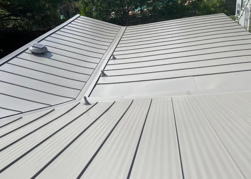 Solar attic fan installed on a metal roof for Roof Ventilation in Goose Creek